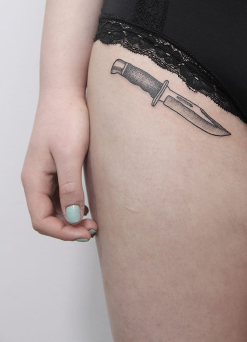 Knife tattoo on the right hip