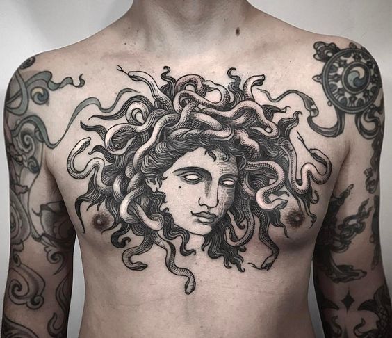 Large black medusa tattoo on the chest