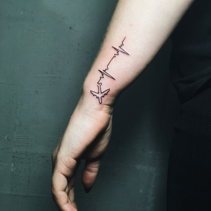 Linear airplane tattoo with a heartbeat wave