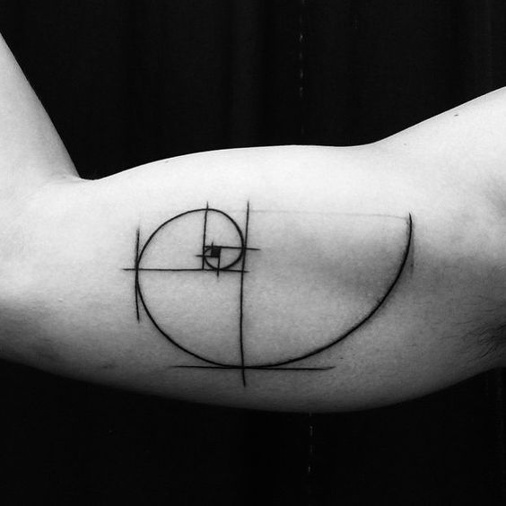 Linear golden spiral tattoo on the right inner bicep
