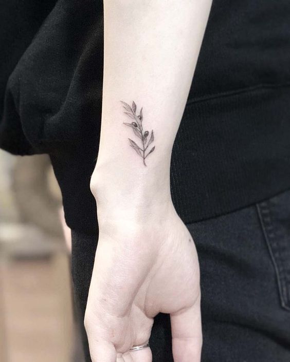 Little olive branch tattoo on the left wrist