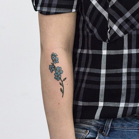 Lovely colorful forget me not twig tattoo
