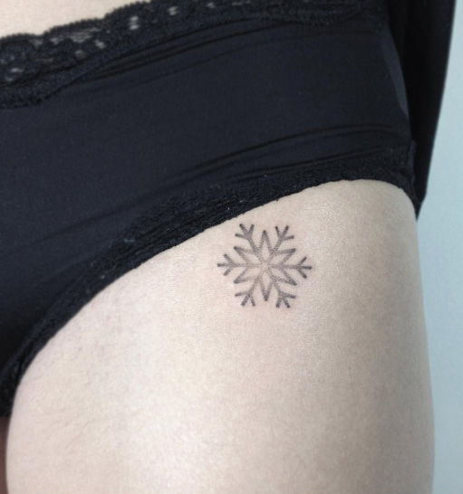 Lovely dotwork snowflake hip tattoo
