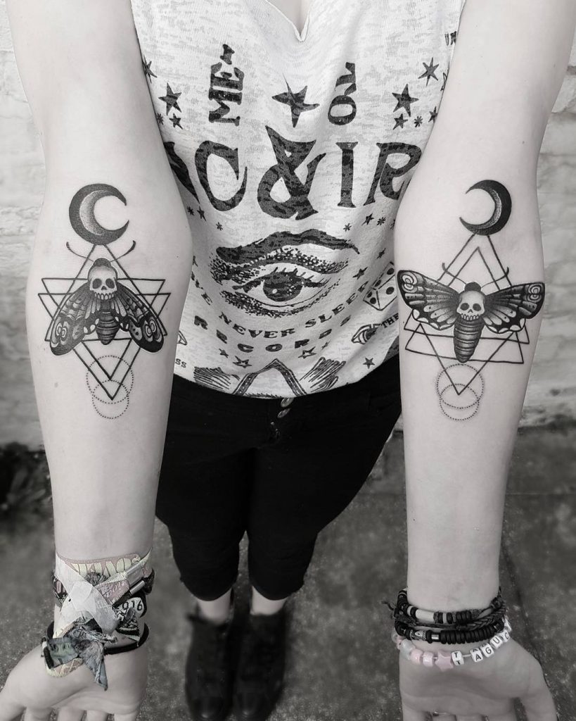Matching death moth tattoos with crescent moons on both inner arms