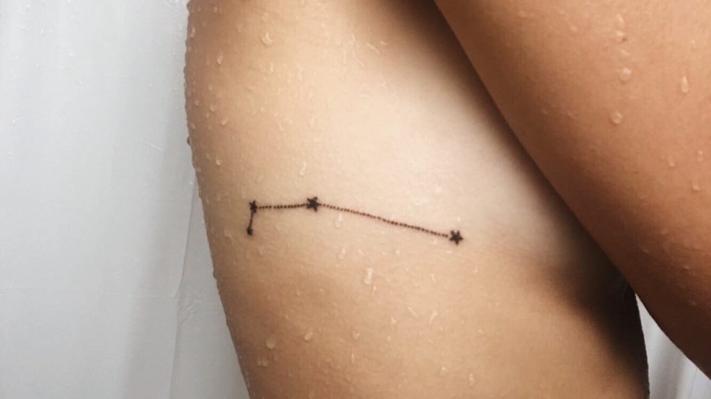 Minimal tattoo of an aries constellation on the right rib cage