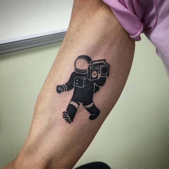 Negative space astronaut with a boombox tattoo