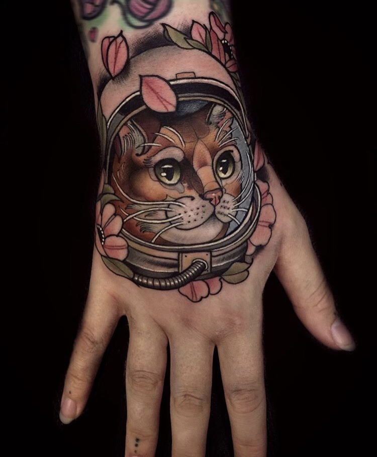 Neo traditional cat astronaut tattoo on the hand by chris green