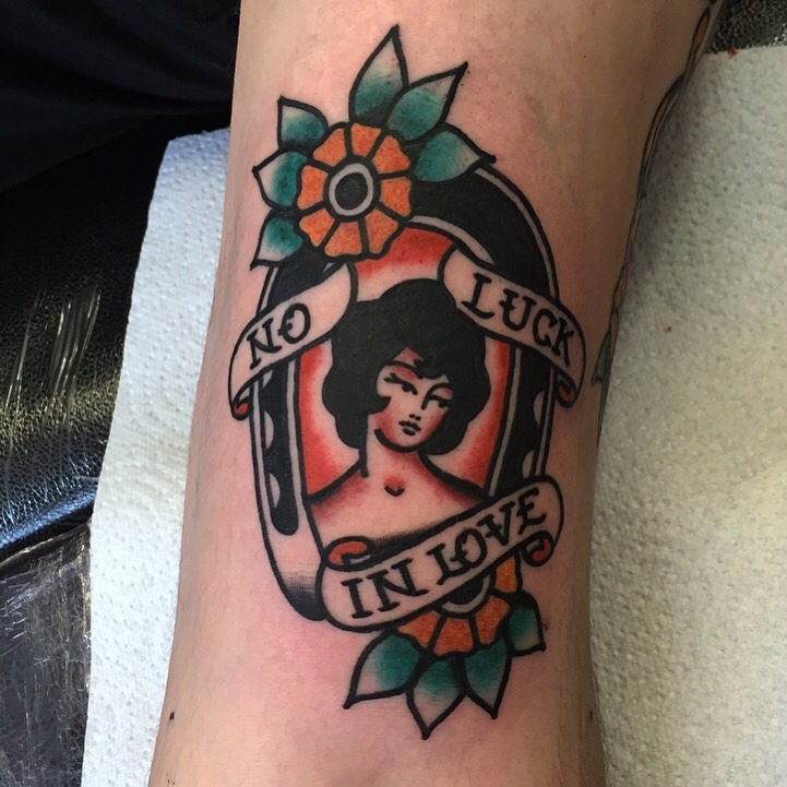 No luck in love downwards horseshoe tattoo