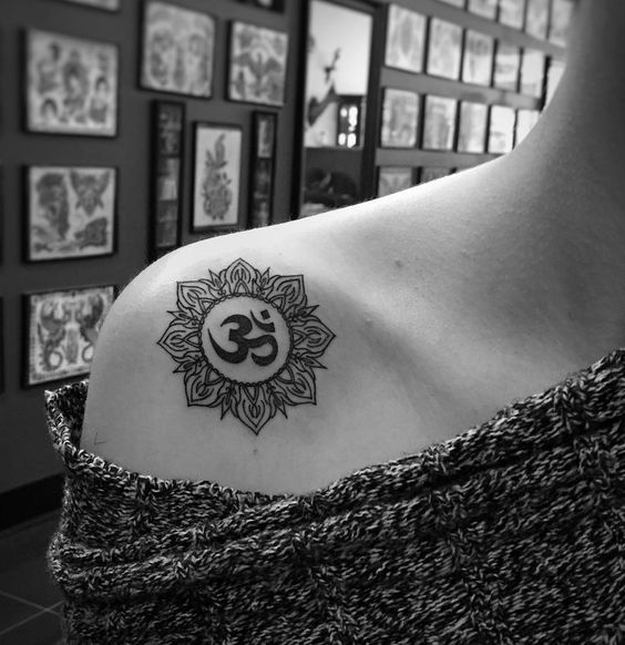 Om in sun tattoo on the right shoulder