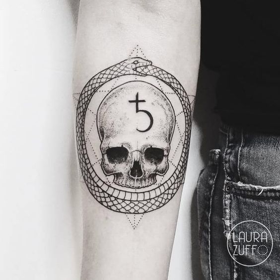 Ouroboros and skull tattoo on the forearm