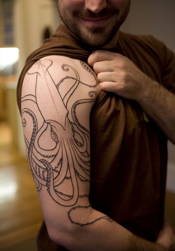 Outline squid tattoo on the right arm