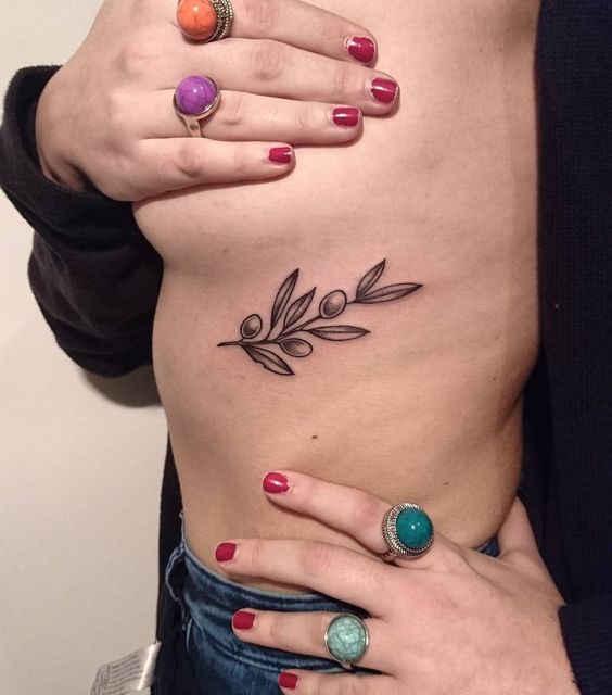 Small and girly olive branch tattoo on the left rib cage