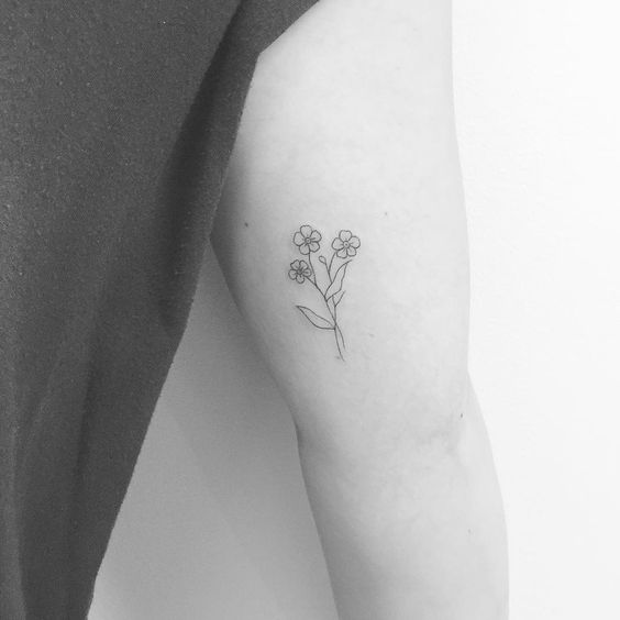 Small black and grey forget me not tattoo on the arm