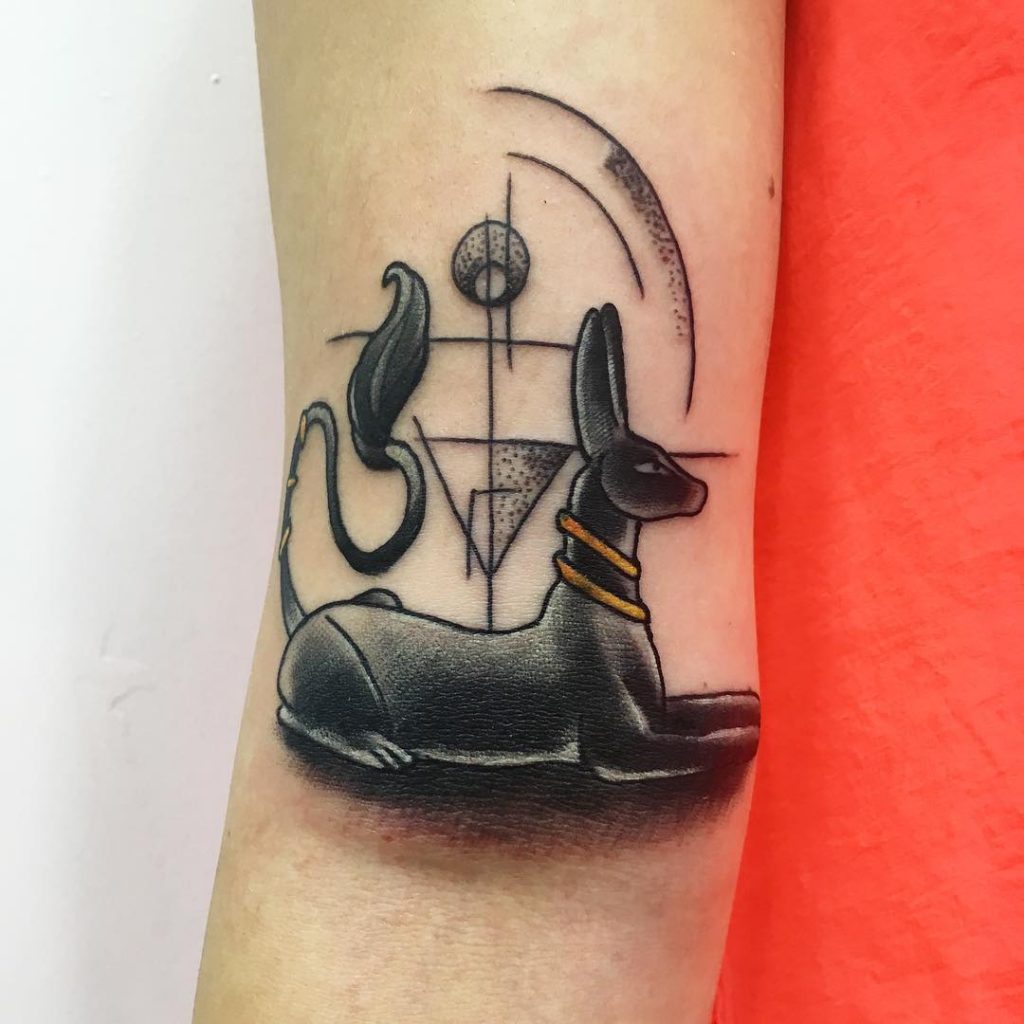 Small black anubis on the arm