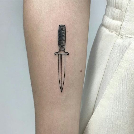 Small boot knife tattoo on the right forearm