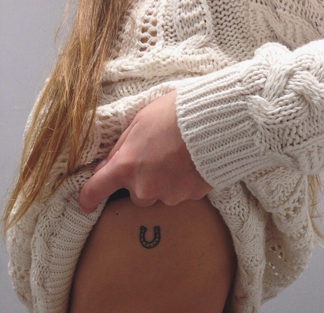 Small horseshoe rib cage tattoo