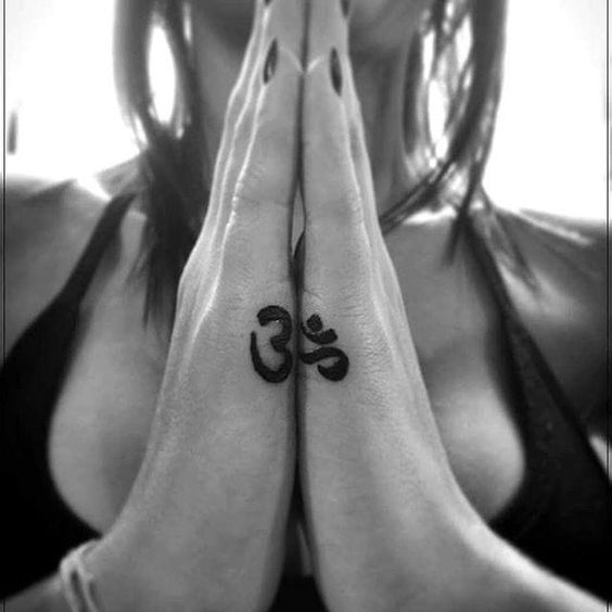 Small matching om tattoo on both hands