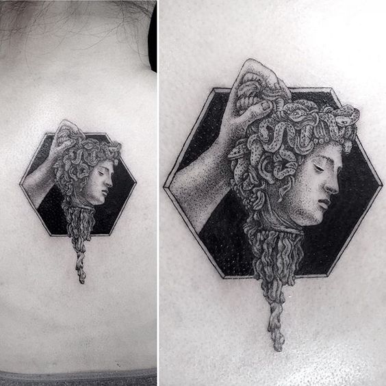 Small medusa head tattoo on the back