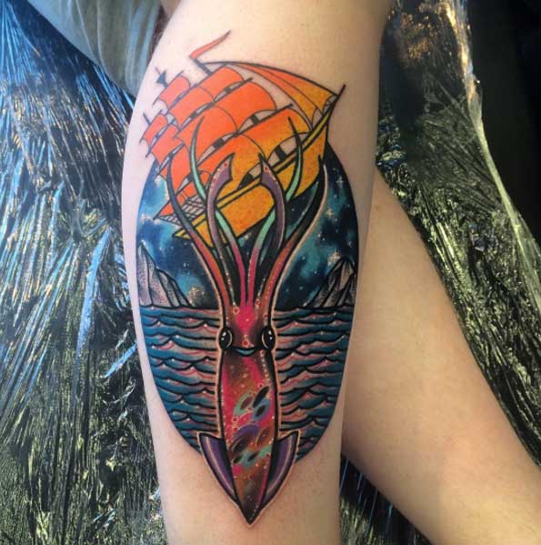 Squid and ship tattoo on the calf