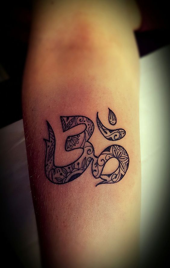 Stylized om tattoo on the arm