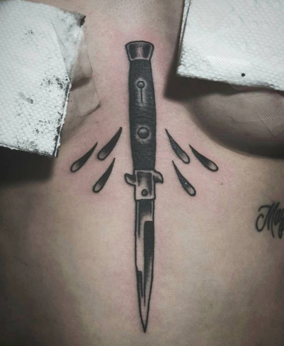 Switchblade tattoo on the sternum