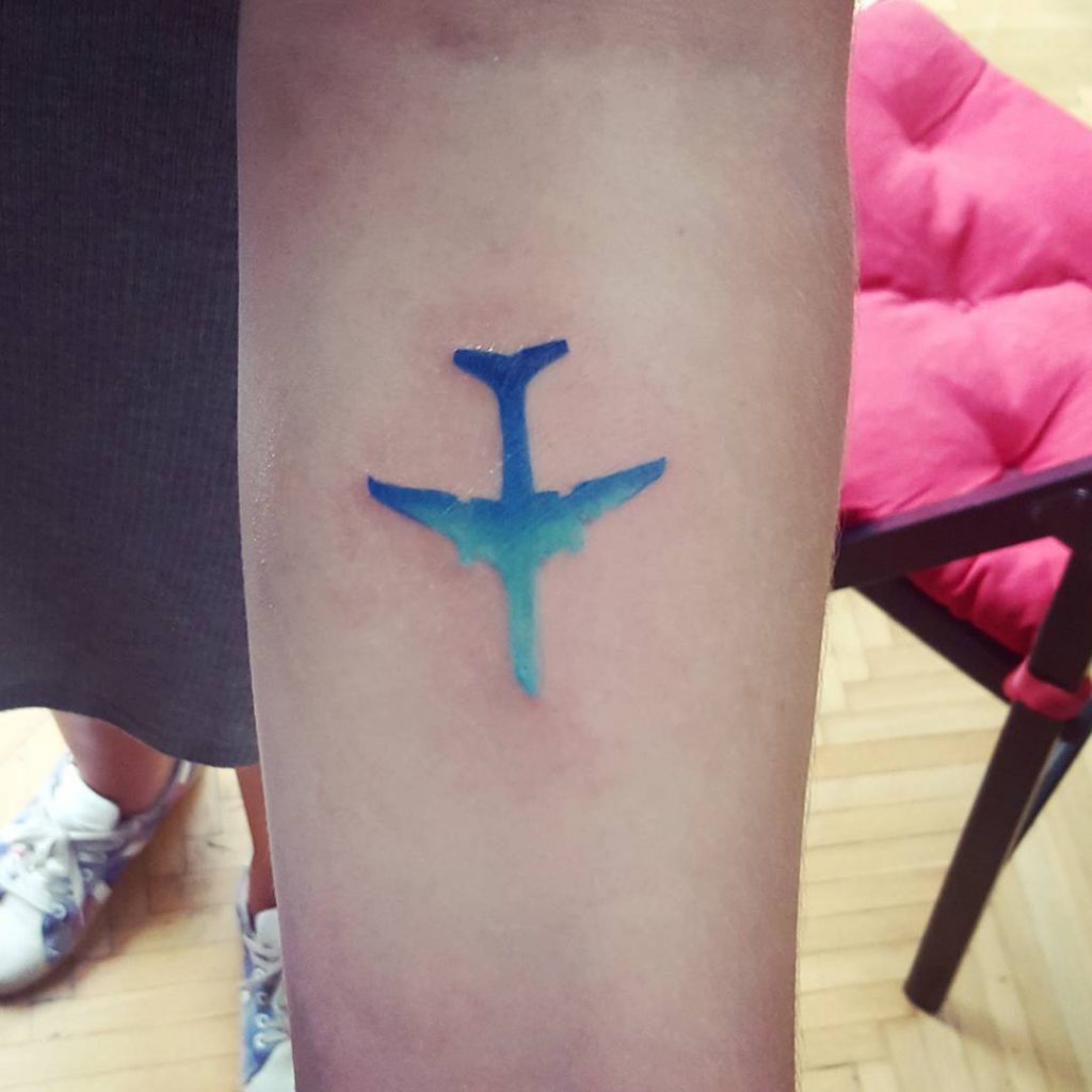 Teal and blue plane on the forearm