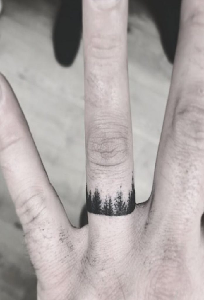 Tiny forest tattoo on the ring finger
