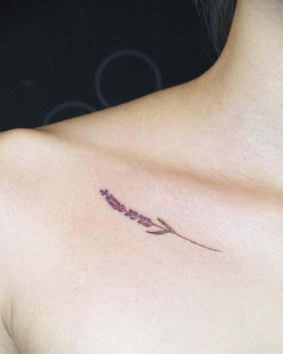 Tiny lavender tattoo on the right collarbone