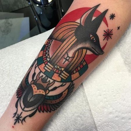 Traditional style anubis tattoo on the leg