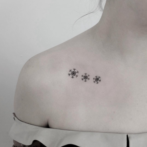 Triple snowflake tattoo on the clavicle bone