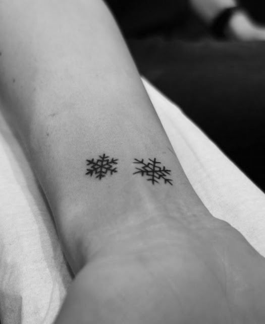 Two snowflakes on the inner wrist