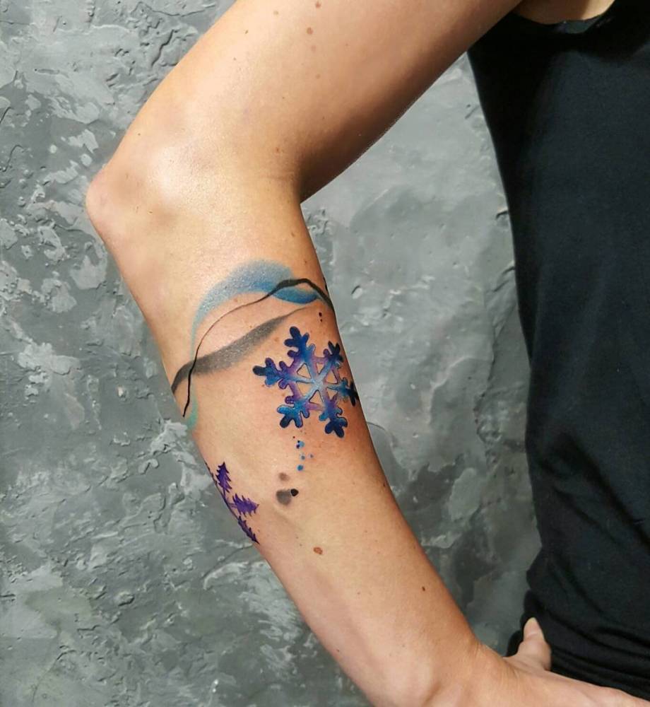 Watercolor snowflakes on the right forearm
