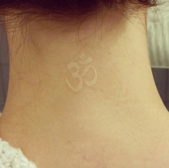 White om tattoo on the back of the neck