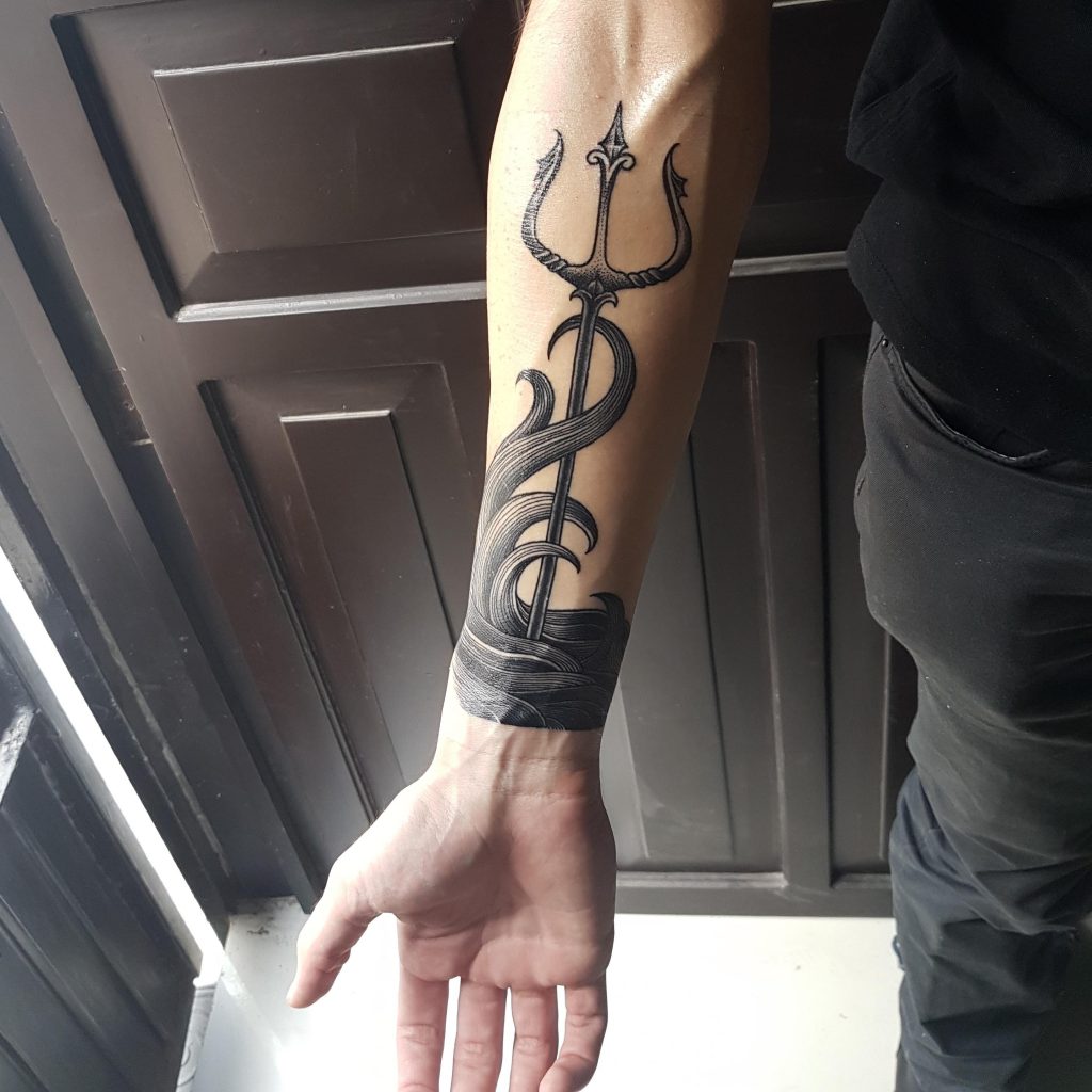 Beautiful blackwork trident on the right inner forearm