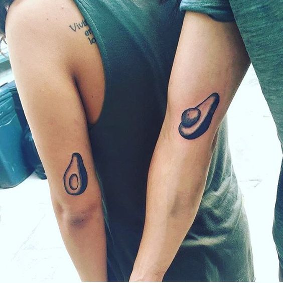 Black and gray matching avocado tattoos for a couple