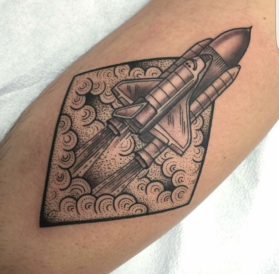 Black and gray spaceplane launch tattoo