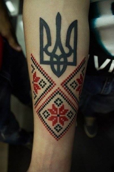 Black trident tattoo with a traditional ukrainian pattern vyshyvanka
