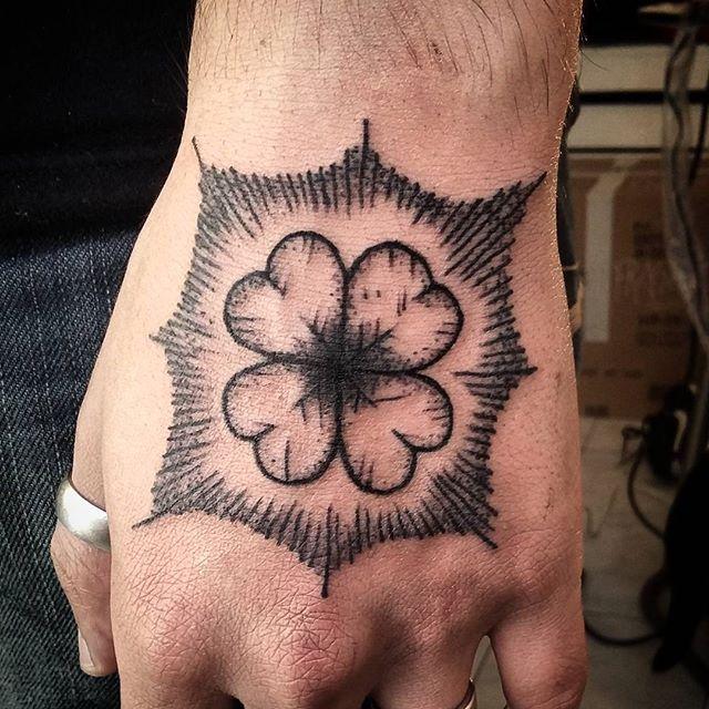Blackwork four leaf clover tattoo on the hand