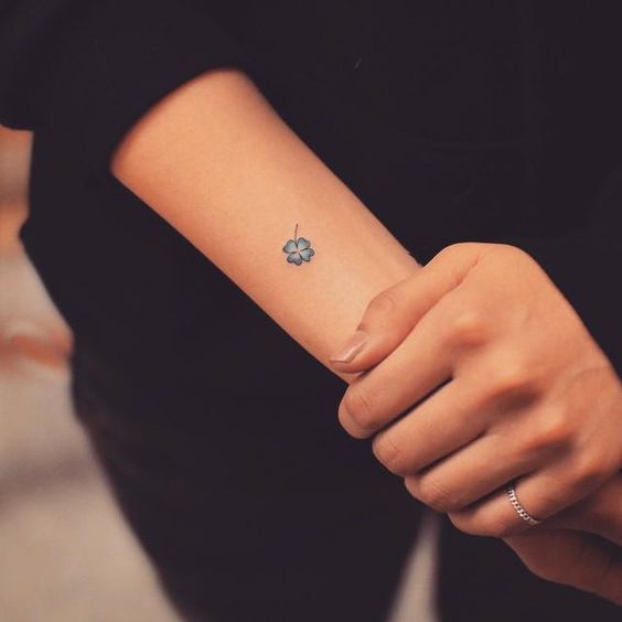 Blue four leaf clover tattoo on the wrist