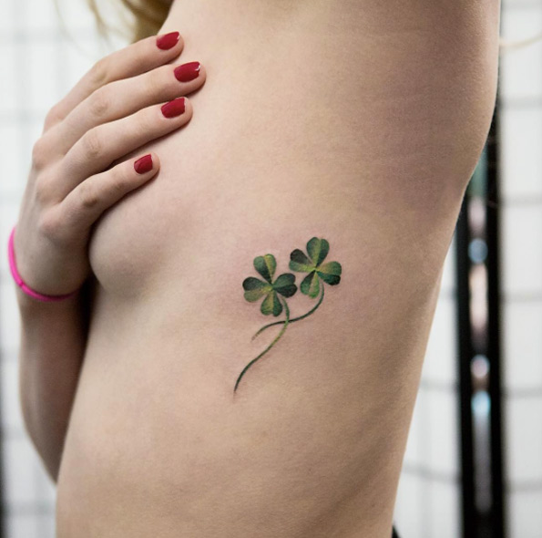 Double green four leaf clover tattoo on the left rib