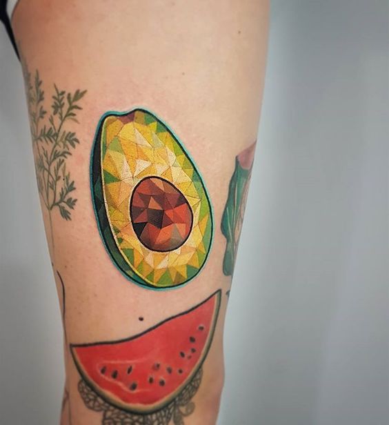 Geometric avocado tattoo on the thigh