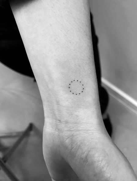 Little dotted circle tattoo on the wrist