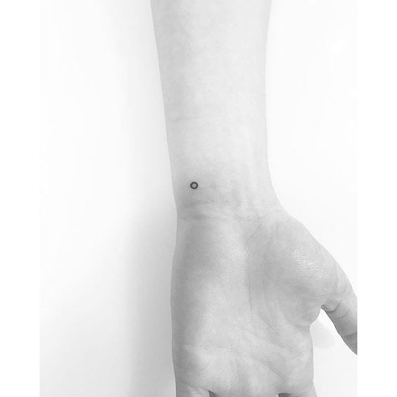 Micro circle tattoo on the inner wrist