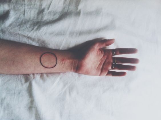 Middle size circle tattoo on the left inner wrist