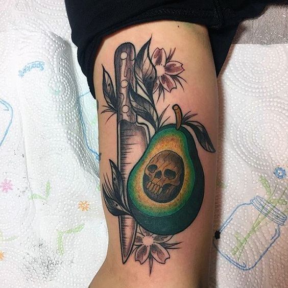 Neo traditional avocado skull and knife tattoo