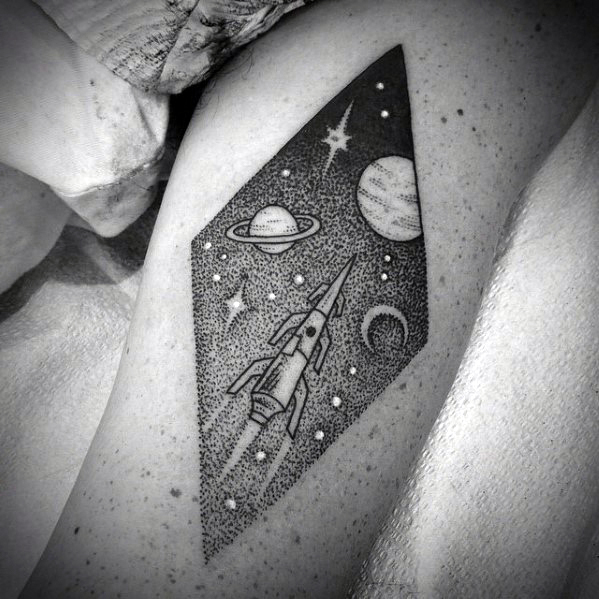 Rhombus shaped dotwork style tattoo of a flying spaceship