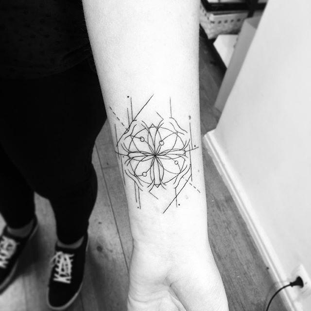 Sacred geometry and four leaf clover tattoo on the inner forearm