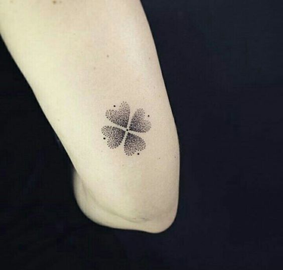 Small dotwork style clover tattoo on the back of the upper arm