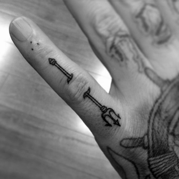 Small trident tattoo on the pinky finger