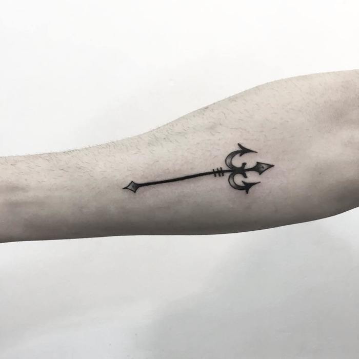 Small trident tattoo